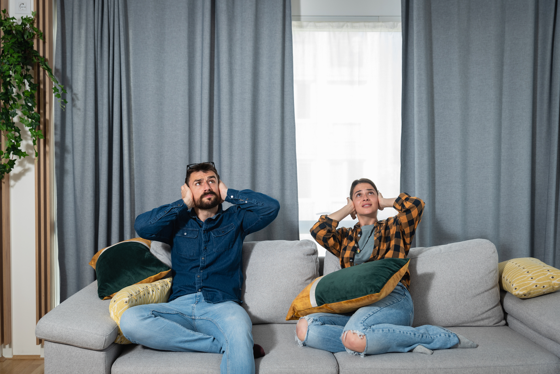 Young,Couple,Is,Sitting,On,A,Sofa,In,Their,Apartment