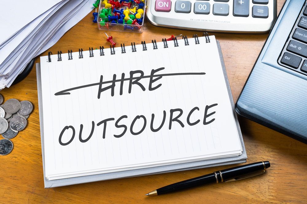 Outsource,Memo,In,Notebook,With,Part,Of,Laptop,,Receipts,And